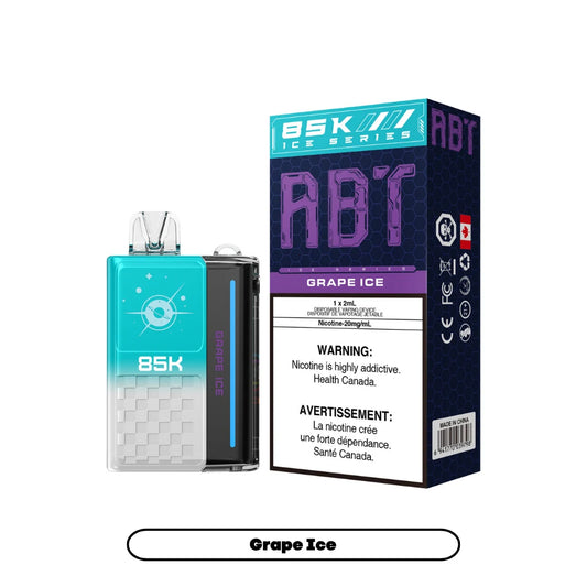 An ABT 85K Grape Ice disposable vape device sits next to its matching teal and purple rectangular packaging, which features the product name, a 20mg/mL nicotine warning, and a Canadian health advisory label.