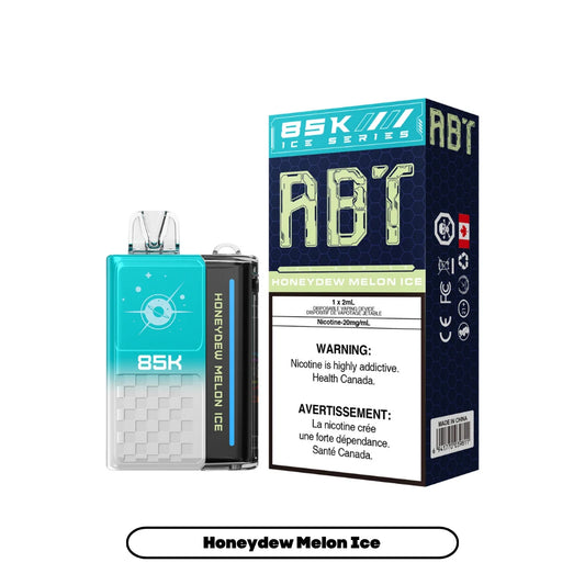 An ABT 85K Honeydew Melon Ice disposable vape device stands next to its matching teal and dark blue product box, which features the flavor name, nicotine concentration, and mandatory health warnings.