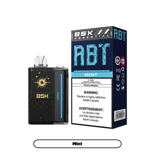 ABT 85K Mint disposable vape device in black with gold celestial graphics next to its blue and black honeycomb patterned packaging featuring the text 85K Essential and Mint.