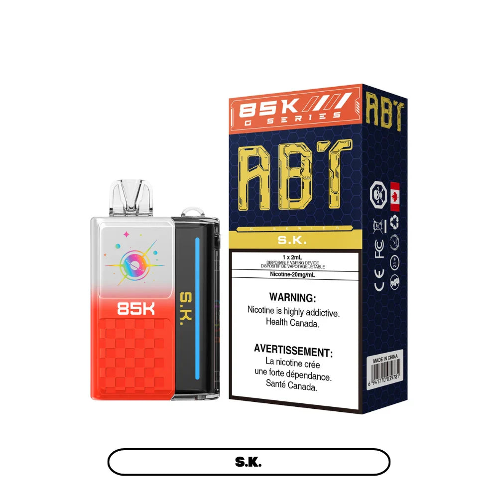 An ABT 85K S.K. disposable vape device with a red and white gradient finish and a celestial graphic stands next to its blue and orange retail box featuring bold ABT and 85K G Series branding.
