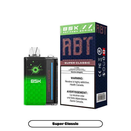 An ABT 85K Super Classic disposable vape device sits next to its green and blue hexagonal-patterned packaging box, which features the product name, a 20mg/mL nicotine warning, and a Canadian health advisory.