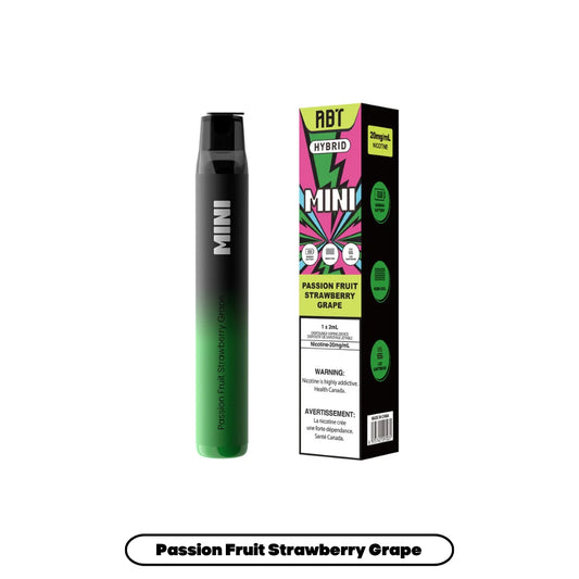 An ABT Hybrid Mini disposable vape pen in a black-to-green gradient finish stands next to its matching product box, which features a vibrant pink and green graphic design, the flavor name Passion Fruit Strawberry Grape, and a 20mg/mL nicotine warning label against a plain white background.