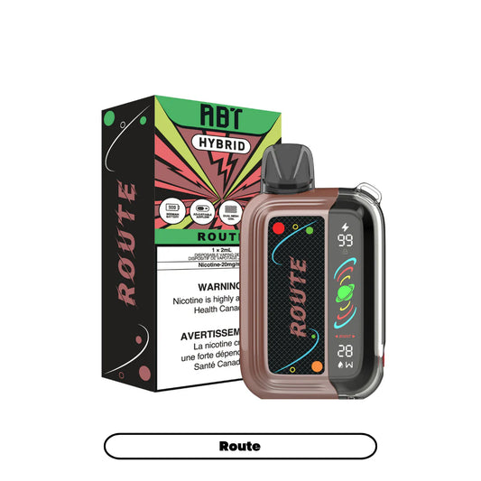 An ABT Hybrid Route disposable vape device in a brown and black finish sits next to its matching product box, which features a green, black, and red graphic design with 900mAh battery, adjustable airflow, and dual mesh coil icons.