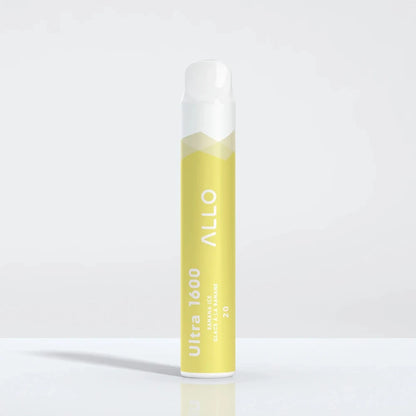A yellow and white Allo Ultra 1600 Banana Ice disposable vape stands upright on a reflective white surface, featuring the text Allo, Ultra 1600, Banana Ice, Glace à la Banane, and 20.