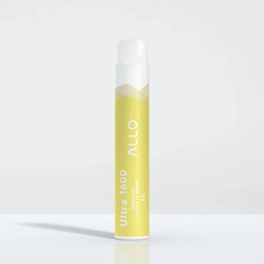 A yellow and white Allo Ultra 1600 Banana Ice disposable vape stands upright on a reflective white surface, featuring the text Allo, Ultra 1600, Banana Ice, Glace à la Banane, and 20.