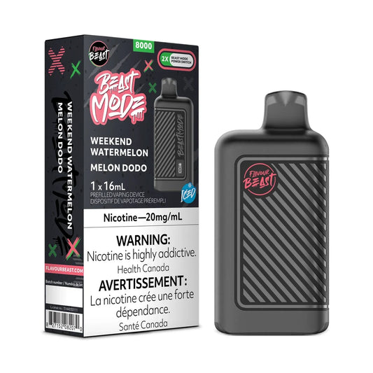 A Flavour Beast Mode 8K disposable vape device in matte black stands next to its retail packaging, which features a black and pink design with Weekend Watermelon Melon Dodo branding and a prominent nicotine warning label.