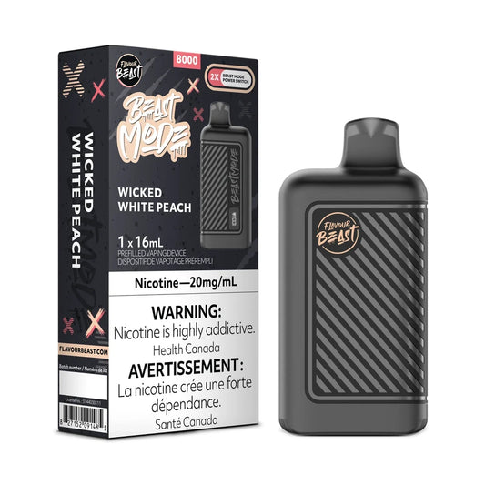 A Flavour Beast Mode 8K disposable vape device in matte black stands next to its matching product box, which features the Wicked White Peach flavor name, a 20mg/mL nicotine warning, and an 8000 puff capacity label against a dark, graphic-patterned background.