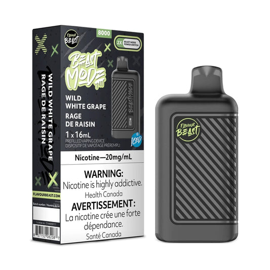 A Flavour Beast Mode 8K Wild White Grape iced disposable vape device stands next to its black and green retail packaging, which features the product name, nicotine concentration, and mandatory health warnings in English and French.