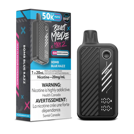 A Flavour Beast Mode Max 2 disposable vape in matte black with a digital display stands next to its matching blue and black packaging box, which features the text Bomb Blue Razz, 50K Puffs, and a nicotine warning.