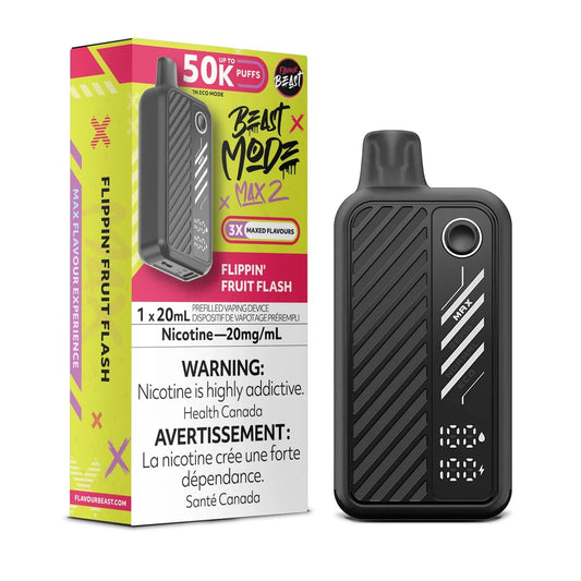 A black Beast Mode Max 2 disposable vape device with a digital display stands next to its yellow and pink retail packaging, which features the product name, a 50,000 puff count, and mandatory nicotine warning labels in English and French.