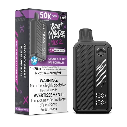 A Flavour Beast Mode Max 2 disposable vape device in black with a digital display screen stands next to its matching purple and black retail packaging, which features the product name, a 50,000 puff count, and nicotine warning labels.