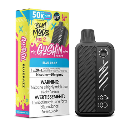 A Beast Mode Max 2 50k Gushin Blue Razz disposable vape stands next to its vibrant yellow and pink packaging, which displays the 20mg/mL nicotine content and a 50,000 puff count, while the black device features a digital display screen and three power settings.