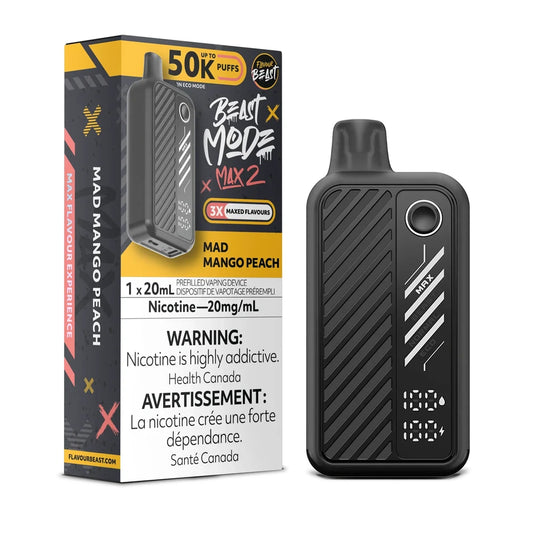 A Flavour Beast Mode Max 2 disposable vape device in black stands next to its matching product packaging, which features yellow and black branding and displays the Mad Mango Peach flavor name, a 20mg/mL nicotine warning, and a 50K puff capacity rating.