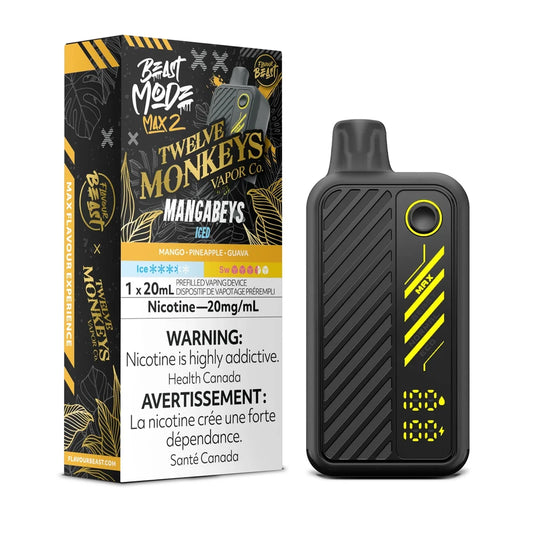 A Beast Mode Max 2 disposable vape device in black with yellow accents stands next to its matching product box, which features Twelve Monkeys Mangabeys Iced branding, a 20mg/mL nicotine warning, and a digital display showing 100 percent for both battery and liquid levels.