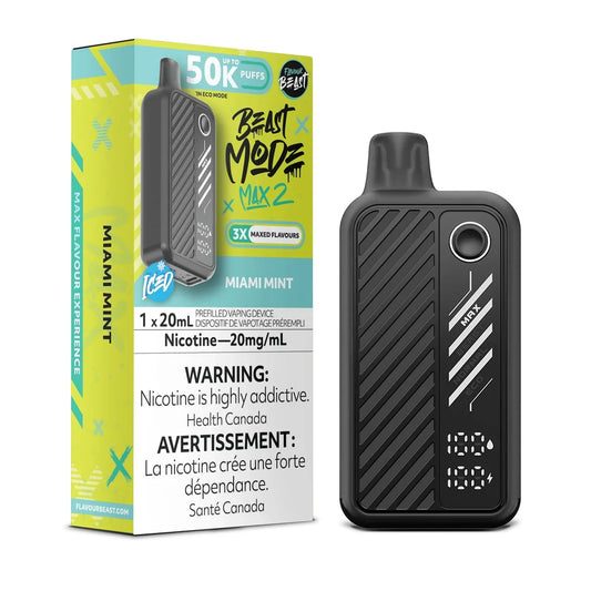 A black Beast Mode Max 2 disposable vape device stands next to its lime green and black product packaging, which displays the Miami Mint flavor name, a 50K puff count, and a 20mg/mL nicotine warning label.
