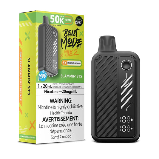 A black Flavour Beast Mode Max 2 disposable vape device stands next to its lime green and black packaging box, which displays the Slammin' STS flavor name, nicotine strength of 20mg/mL, and a 50k puff count rating.