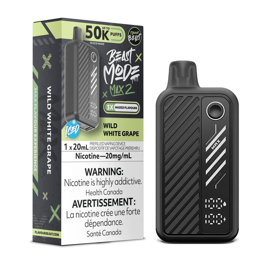 A black Flavour Beast Mode Max 2 disposable vape device stands next to its matching product box, which features green and black branding, the flavor name Wild White Grape Iced, and a 20mg/mL nicotine warning label.