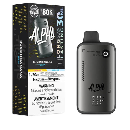 A Flavour Beast Alpha 80k disposable vape in Bussin Banana Iced flavor stands next to its black and yellow retail box, which features a 30mL capacity label, a 20mg/mL nicotine warning, and a digital display on the grey metallic device.