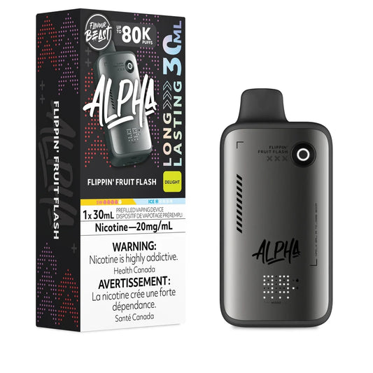 A Flavour Beast Alpha 80k disposable vape in a matte grey finish stands next to its black and purple retail box, both labeled Flippin' Fruit Flash with a 20mg/mL nicotine concentration.