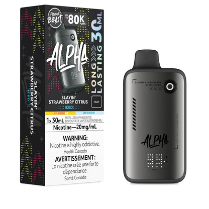A Flavour Beast Alpha 80k disposable vape device in matte grey stands next to its black retail box featuring the Slayin' Strawberry Citrus Iced flavor name, 20mg/mL nicotine strength, and 30mL capacity labeling.