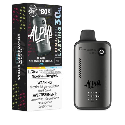 A Flavour Beast Alpha 80k disposable vape device in matte grey stands next to its black retail box featuring the Slayin' Strawberry Citrus Iced flavor name, 20mg/mL nicotine strength, and 30mL capacity labeling.
