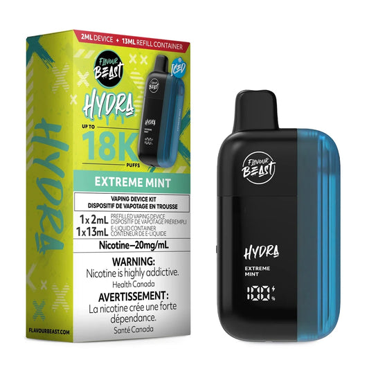 A Flavour Beast Hydra Extreme Mint disposable vape device stands next to its lime green and black product packaging, which displays the 18K puff count, 20mg/mL nicotine strength, and a 2ml device plus 13ml refill container configuration.