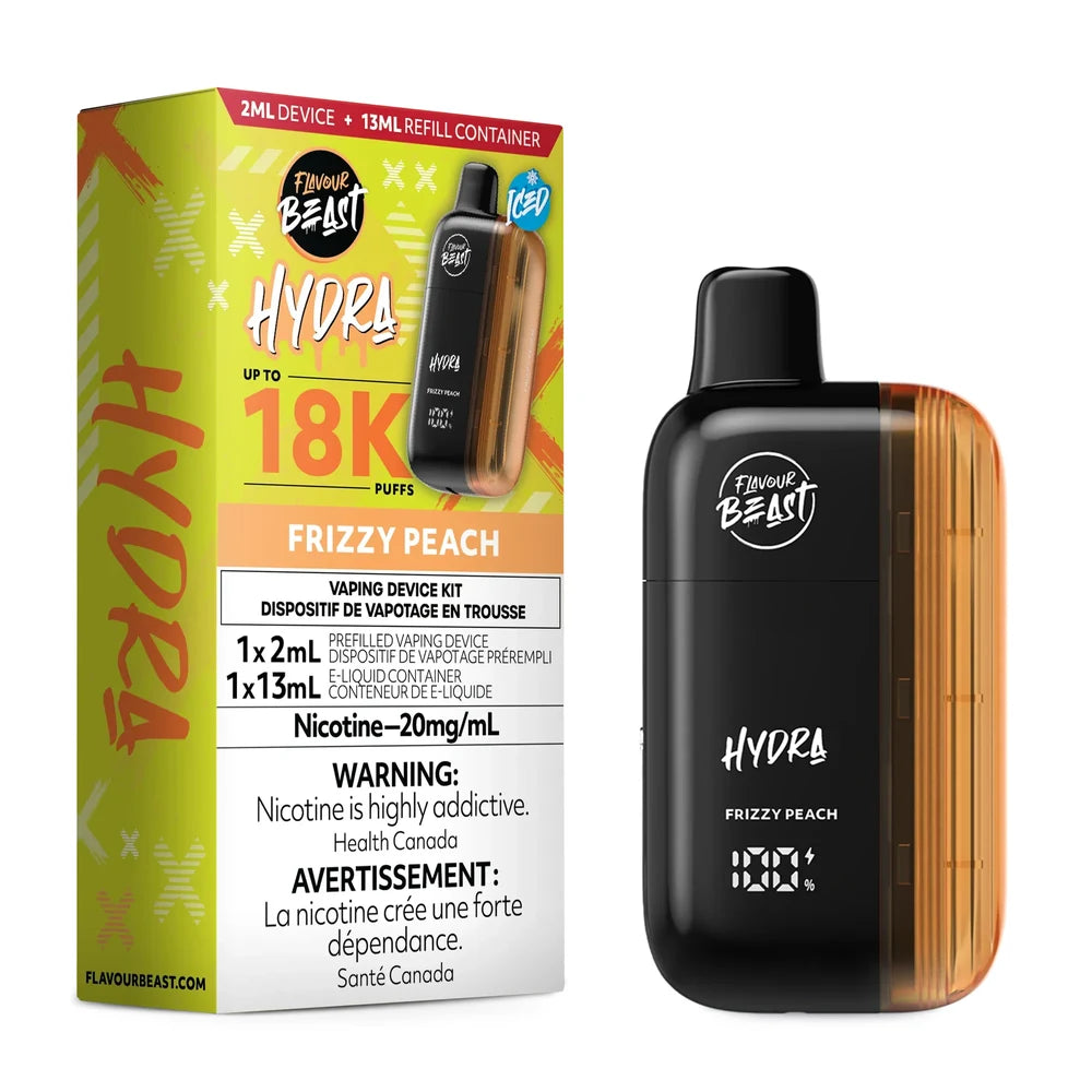 A Flavour Beast Hydra Frizzy Peach disposable vape device stands next to its yellow and orange retail box, which features the product name, a 18K puff count, and nicotine warning labels in English and French.