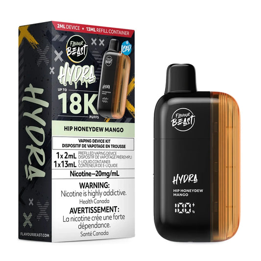 A Flavour Beast Hydra Hip Honeydew Mango disposable vape device stands next to its black and orange packaging, which displays the product name, a 18K puff count, and nicotine warning labels.