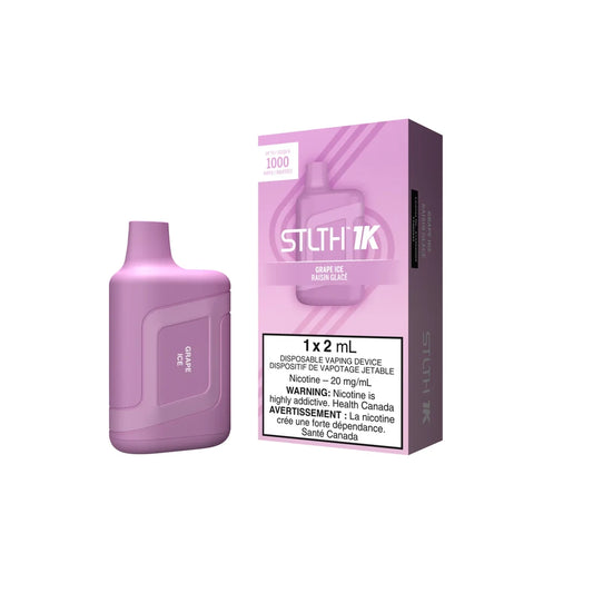 A purple STLTH 1K Grape Ice disposable vape device stands next to its matching purple and white packaging, which features the STLTH 1K logo and a nicotine warning label.