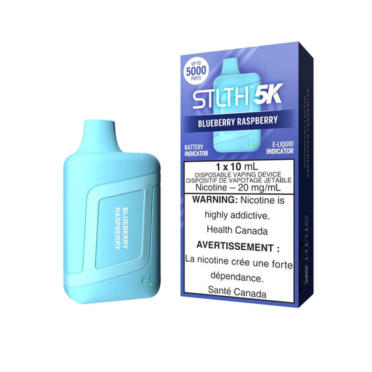 A light blue STLTH 5K Blueberry Raspberry disposable vape device stands next to its purple and blue retail packaging featuring the STLTH 5K logo and a nicotine warning label.