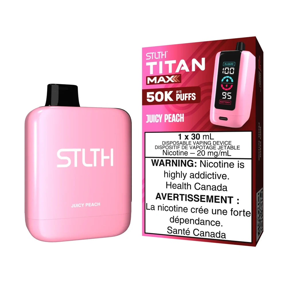 A light pink STLTH Titan Max 50K Juicy Peach disposable vape device stands next to its matching pink and red retail packaging featuring a digital display and nicotine warning labels.