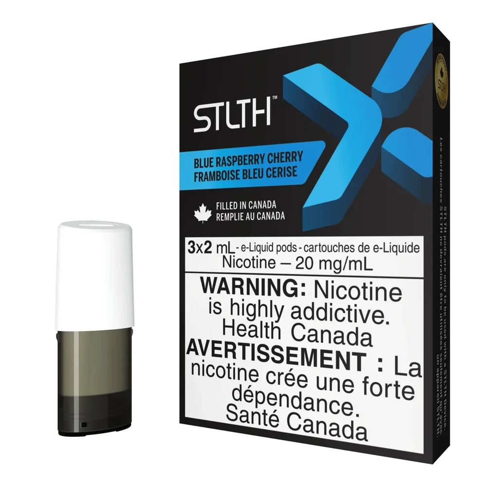 A single STLTH X Blue Raspberry Cherry e-liquid pod stands next to its black packaging featuring a large blue X logo and text that reads Blue Raspberry Cherry Framboise Bleu Cerise.