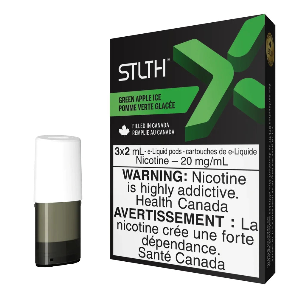 A single STLTH X Green Apple Ice pod with a white mouthpiece stands next to its black and green packaging featuring a large green X logo and health warning labels.